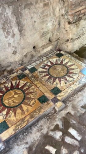 Tourist documents ancient interiors at Hadrian's Villa, Tivoli