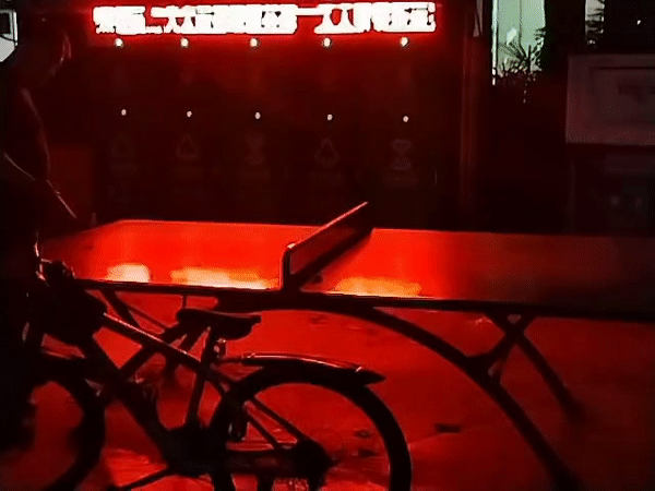 Nighttime courtyard activity captured from rooftops in Yuzhong District