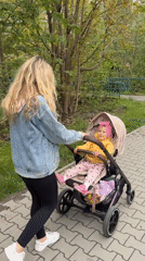 Woman pushes baby stroller on path in Wisła, Poland