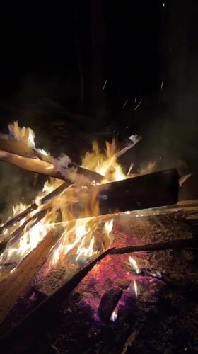 Evening gathering around bonfire in rural Russian village