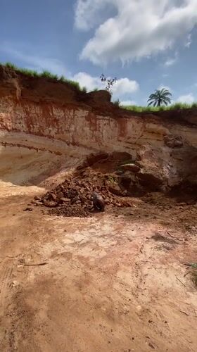 Man sorts through rocks in Igbarra, Nigeria