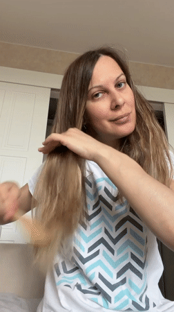 Morning routine documented in Izhevsk home with woman and cat