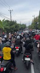 Heavy motorcycle traffic jam clogs Denpasar road