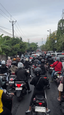 Heavy motorcycle traffic jam clogs Denpasar road