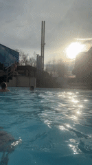 Families enjoy swimming at outdoor pool facility in Glazov