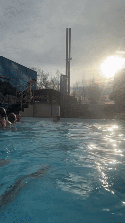 Families enjoy swimming at outdoor pool facility in Glazov
