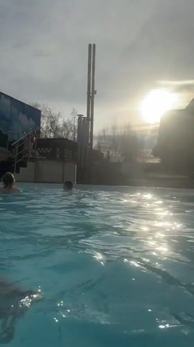 Families enjoy swimming at outdoor pool facility in Glazov