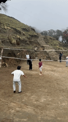 Volleyball game played on dirt court in Nepal village