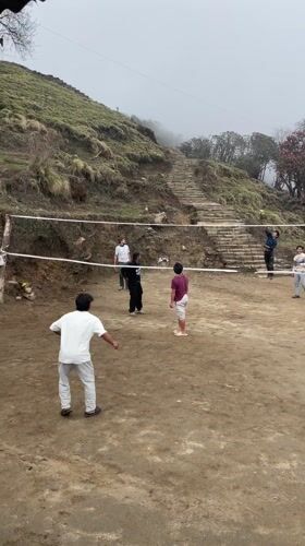 Volleyball game played on dirt court in Nepal village