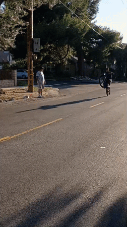 Motorcyclist performs wheelie on Los Angeles residential street