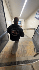 Woman in A3B jacket descends subway stairs in Buenos Aires