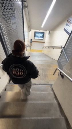 Woman in A3B jacket descends subway stairs in Buenos Aires