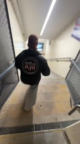 Woman in A3B jacket descends subway stairs in Buenos Aires