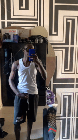 Mirror selfie in a patterned bedroom, Lokoja