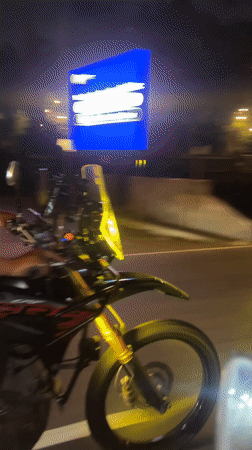 Motorcyclists ride through Denpasar streets in evening hours