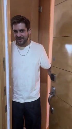 Man enters room smiling in Mexico City evening