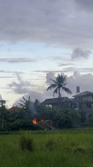 Aircraft spotted over rural Sukawati rice fields leaving contrail