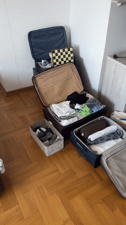 Packing scene documented in Podgorica room with scattered clothing