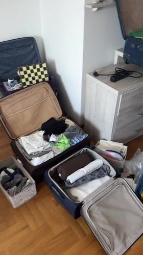 Packing scene documented in Podgorica room with scattered clothing