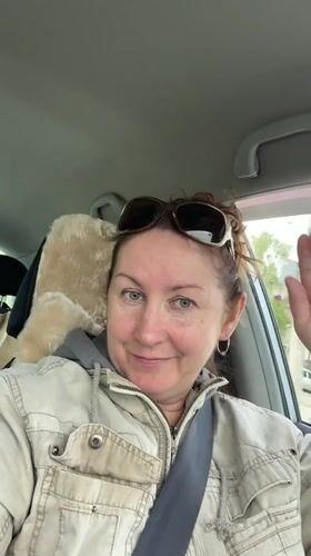 Driver waves at camera while driving in Barnaul