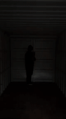 Masked person uses flashlight inside cargo container in North Weald