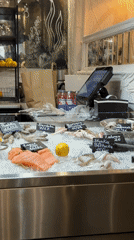 Seafood vendor serves fresh fish at Warsaw restaurant display