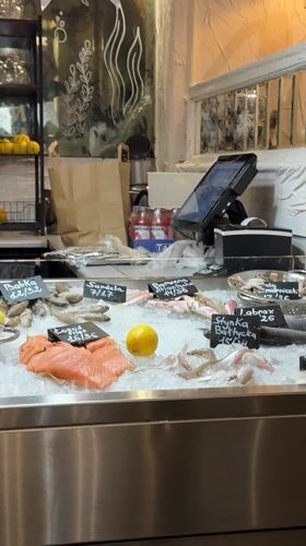 Seafood vendor serves fresh fish at Warsaw restaurant display