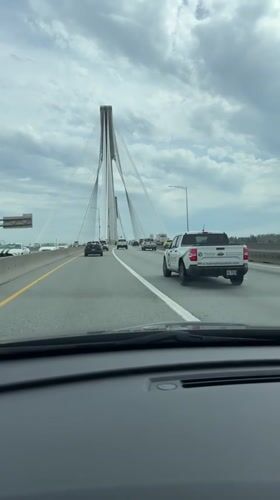 Evening traffic flows across cable-stayed bridge in Coquitlam