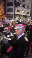 Nighttime street parade rolls through La Paz with brass band