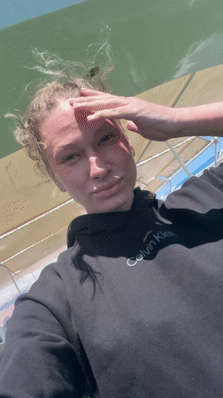 Woman takes selfie on boat in Dahab, Egypt