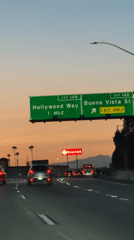 Highway drive through Burbank at dusk, Hollywood Way exit ahead