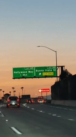 Highway drive through Burbank at dusk, Hollywood Way exit ahead