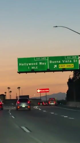 Highway drive through Burbank at dusk, Hollywood Way exit ahead