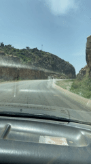 Vehicle travels mountain pass road near Vom, Nigeria