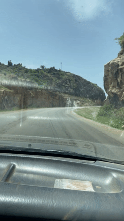 Vehicle travels mountain pass road near Vom, Nigeria