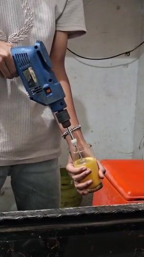 Person uses power drill to mix drink in Keudebayu