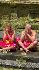 Religious ceremony at Indonesian Hindu temple involves robed participants