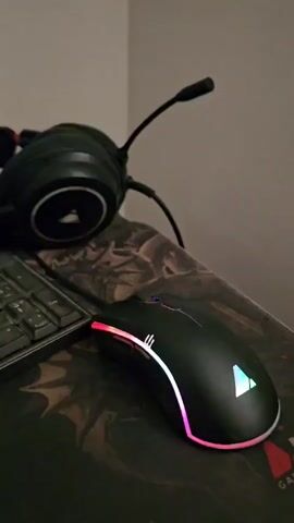 The video begins with a close-up shot of a gaming mouse and headphones on a desk. The mouse has RGB lighting around its edges. The camera then pans up to a computer monitor displaying the time as 19:52 and the date as Monday, September 14th. The monitor has an LG logo at the bottom.