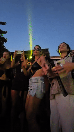 DJ performs seaside sunrise set with laser show in Brazil