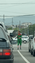 Street performer juggles in elf costume at Sofia intersection