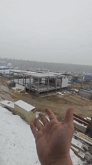 Dogs inhabit snowy Russian construction site during overcast morning