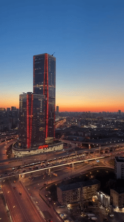 Dusk view captures illuminated Khimki cityscape and highways