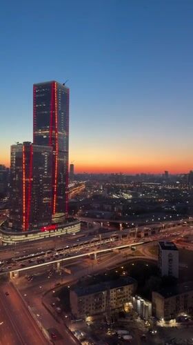Dusk view captures illuminated Khimki cityscape and highways