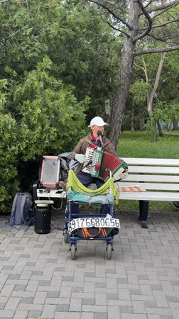 Street musicians perform accordion and saxophone in Anapa