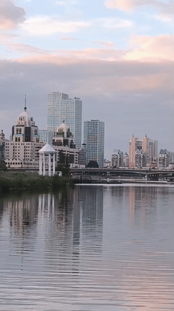 Duck family on Astana waterway at golden hour