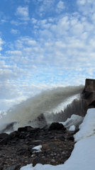 Water spillway and waves observed at rocky Chernushka shoreline