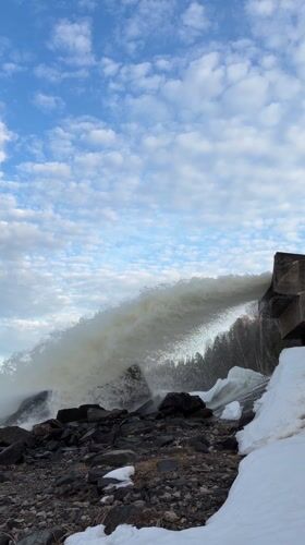 Water spillway and waves observed at rocky Chernushka shoreline