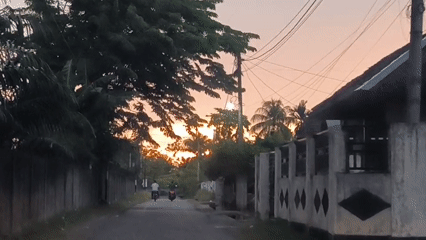 Sunset captured from two Indonesian villages during evening rain