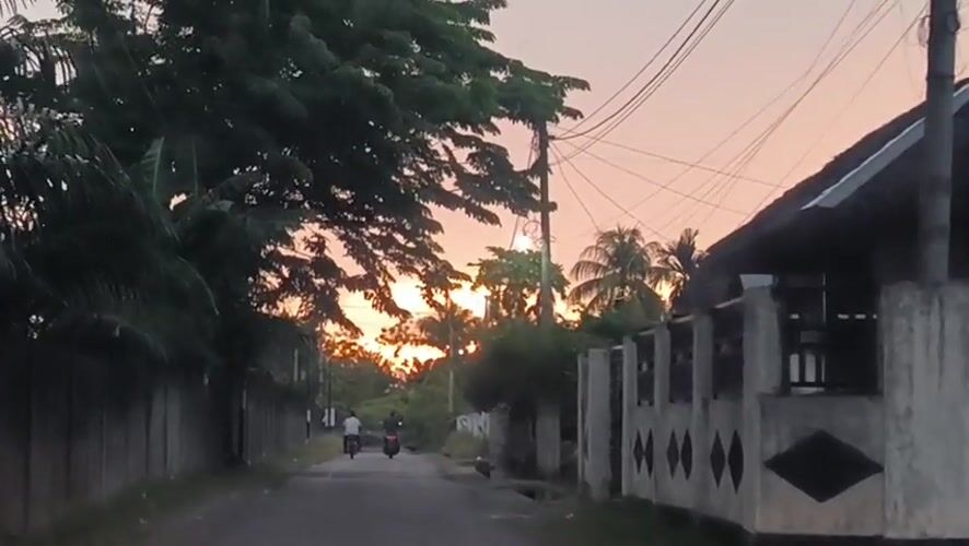 Sunset captured from two Indonesian villages during evening rain