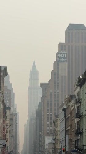 Hazy skies hang low over a New York City street.